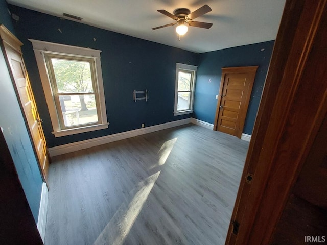 unfurnished bedroom featuring hardwood / wood-style flooring and ceiling fan