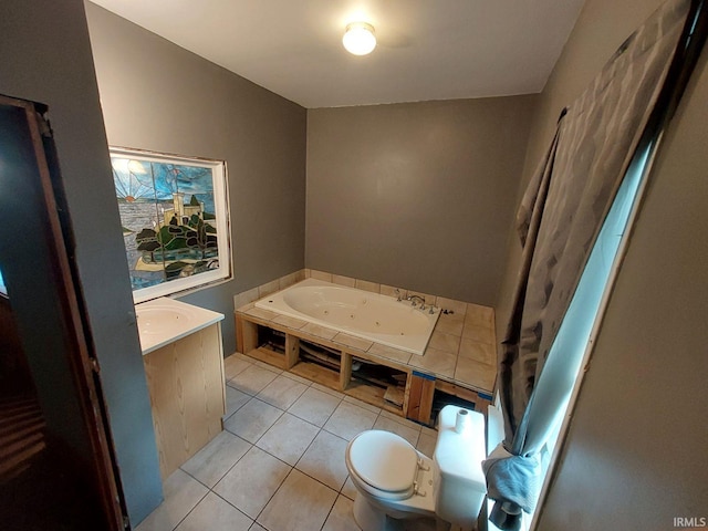 bathroom featuring tile patterned flooring, a tub to relax in, and toilet