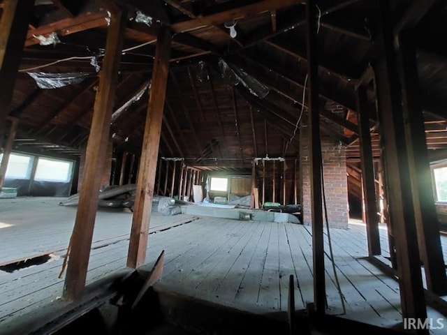 unfinished attic featuring a healthy amount of sunlight