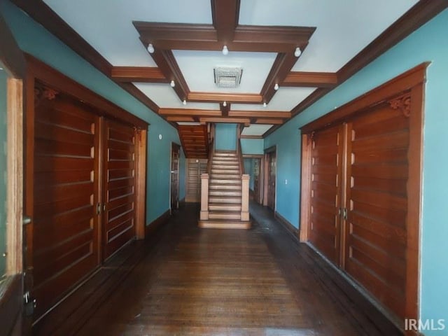 hallway with coffered ceiling, beamed ceiling, dark hardwood / wood-style floors, and ornamental molding