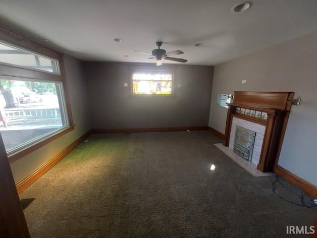 unfurnished living room with ceiling fan and carpet floors