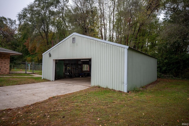 view of outdoor structure with a yard and a garage