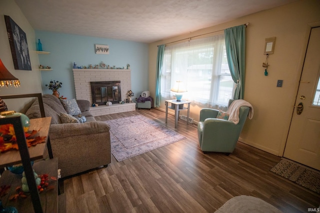 living room with a fireplace, hardwood / wood-style floors, and a textured ceiling