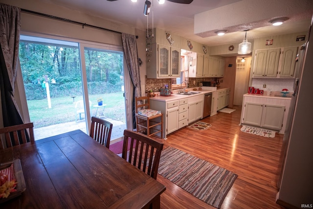 dining room featuring light hardwood / wood-style floors, sink, a textured ceiling, and ceiling fan