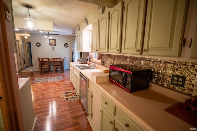 kitchen with light hardwood / wood-style flooring, sink, decorative backsplash, hanging light fixtures, and stainless steel dishwasher