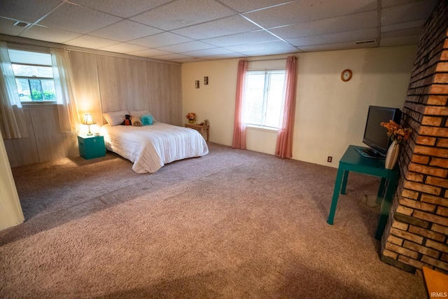 carpeted bedroom featuring a paneled ceiling