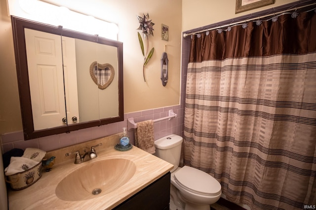 bathroom with vanity, tile walls, toilet, and a shower with curtain