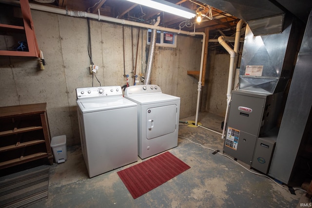 laundry room featuring heating unit and separate washer and dryer