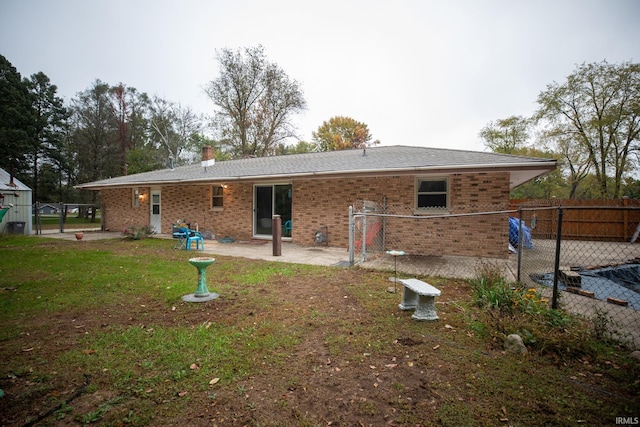 rear view of property with a lawn and a patio