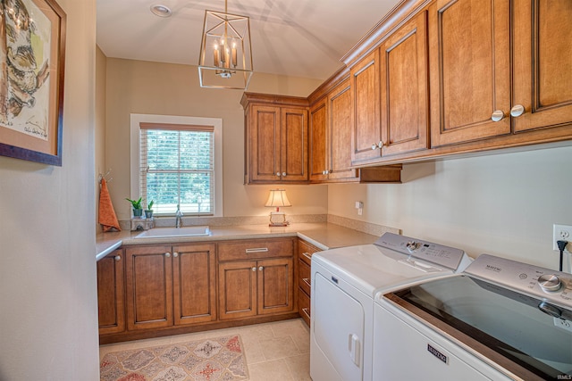 laundry room featuring sink, a notable chandelier, cabinets, washer and dryer, and light tile patterned floors