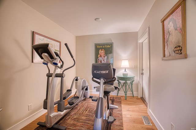 workout room with light hardwood / wood-style floors