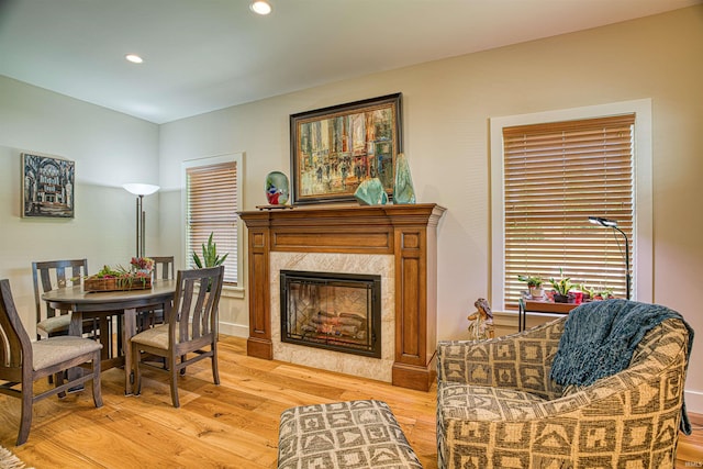 sitting room with a premium fireplace and light wood-type flooring