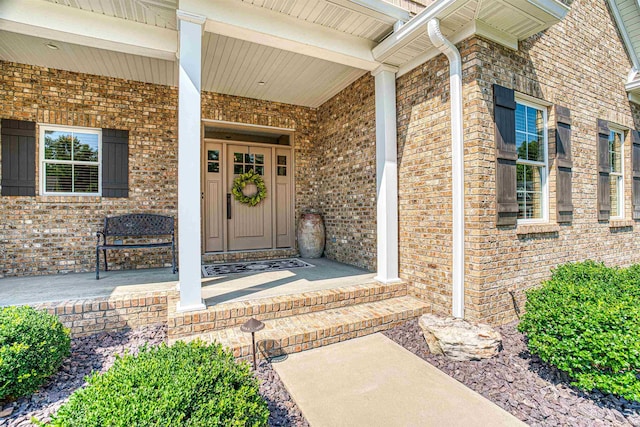 view of exterior entry with a porch