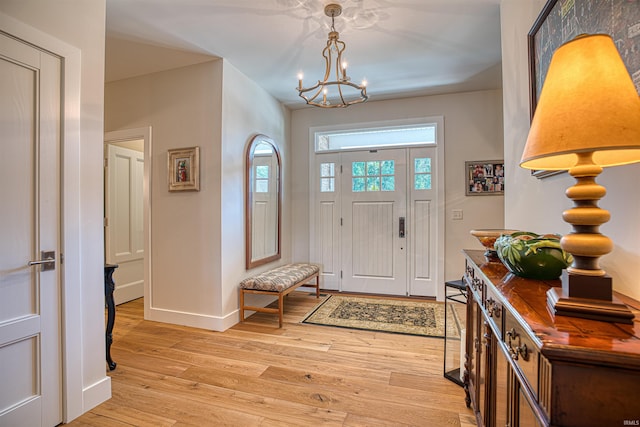 entrance foyer featuring a notable chandelier and light hardwood / wood-style floors