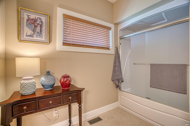 bathroom with bath / shower combo with glass door and vanity