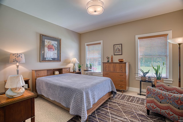 carpeted bedroom with multiple windows