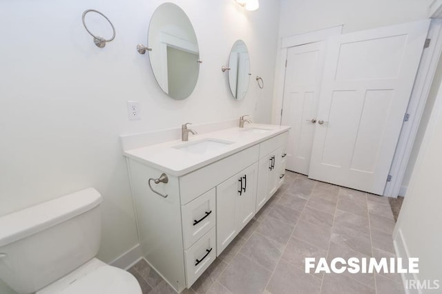 bathroom featuring vanity and toilet