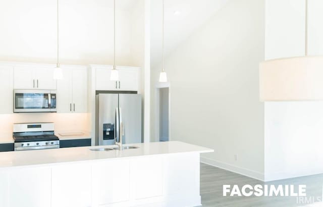 kitchen featuring appliances with stainless steel finishes, pendant lighting, sink, and white cabinets