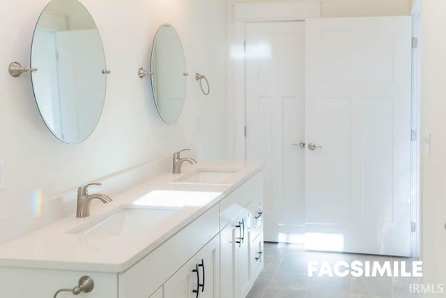 bathroom with tile patterned flooring and vanity