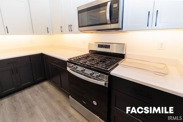 kitchen featuring light hardwood / wood-style floors, white cabinetry, and stainless steel appliances