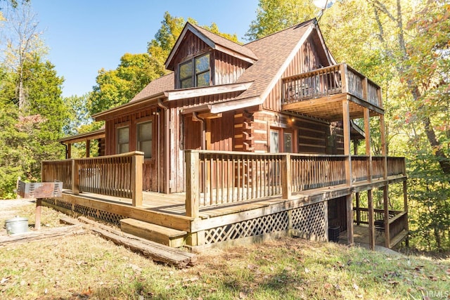 rear view of house with a wooden deck