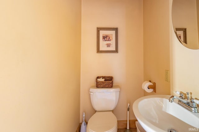 1291 N Sewell Rd, Bloomington, IN 47408 - bathroom featuring a sink, toilet, and baseboards