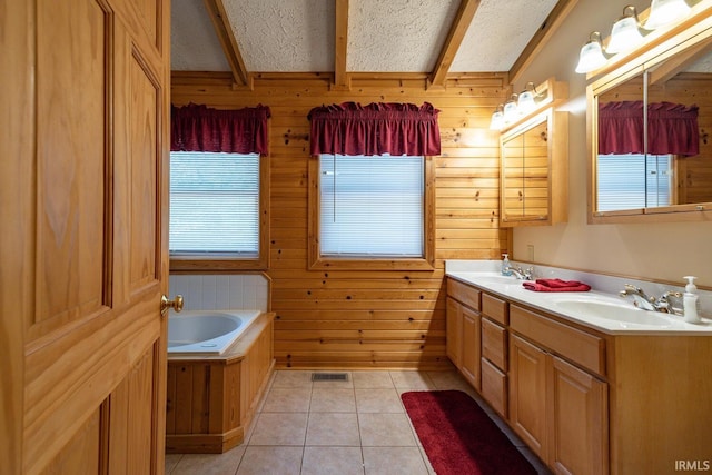 bathroom with vanity, a bathtub, wood walls, a textured ceiling, and tile patterned flooring