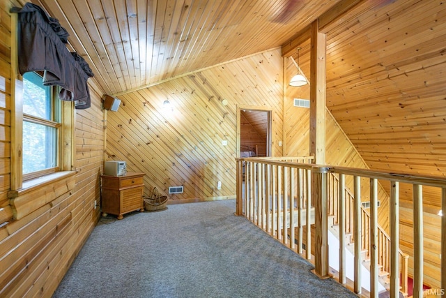 bonus room featuring lofted ceiling, carpet floors, wood walls, and wood ceiling