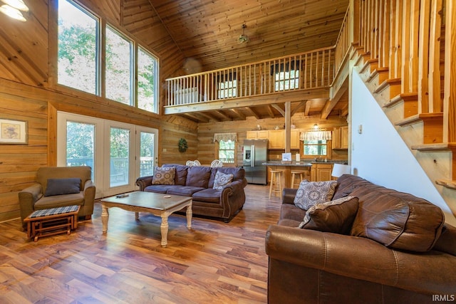 living room with hardwood / wood-style flooring, wood ceiling, plenty of natural light, and high vaulted ceiling