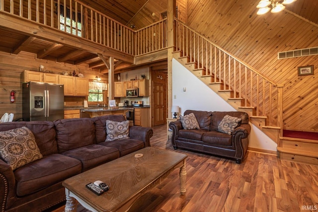 living room featuring hardwood / wood-style flooring, wooden walls, high vaulted ceiling, and wooden ceiling