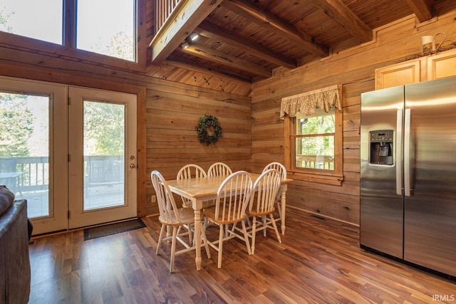 dining space with beamed ceiling, wood walls, dark hardwood / wood-style flooring, and wooden ceiling