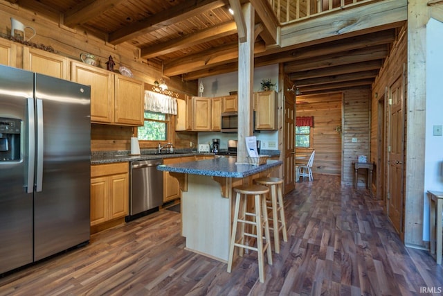 1291 N Sewell Rd, Bloomington, IN 47408 - kitchen with appliances with stainless steel finishes, wooden walls, wooden ceiling, a breakfast bar area, and light brown cabinets