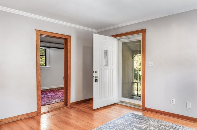 entrance foyer featuring ornamental molding and hardwood / wood-style flooring