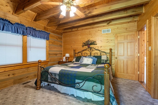 carpeted bedroom with wood ceiling, beam ceiling, wooden walls, and ceiling fan