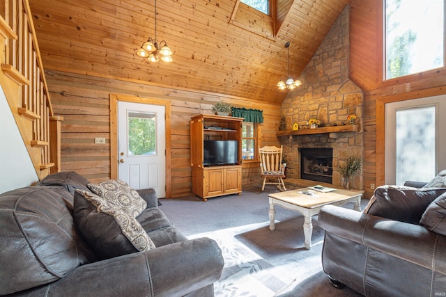 carpeted living room featuring wood walls, a healthy amount of sunlight, high vaulted ceiling, and a fireplace