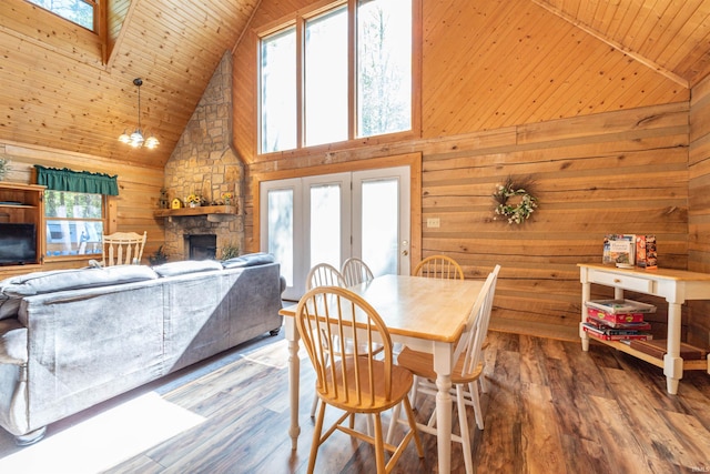 dining room with high vaulted ceiling, a healthy amount of sunlight, and hardwood / wood-style floors