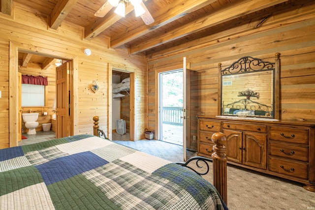 bedroom featuring ceiling fan, access to exterior, ensuite bathroom, beamed ceiling, and light colored carpet