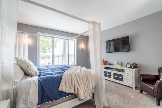 bedroom featuring light colored carpet