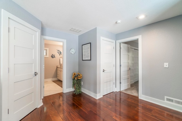 hall with dark wood-type flooring