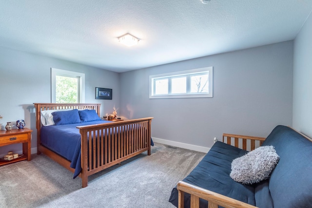 carpeted bedroom with a textured ceiling