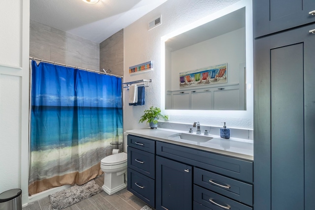 bathroom with vanity, toilet, hardwood / wood-style flooring, and a shower with shower curtain