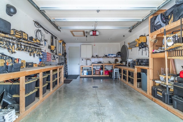 garage with a workshop area and a garage door opener