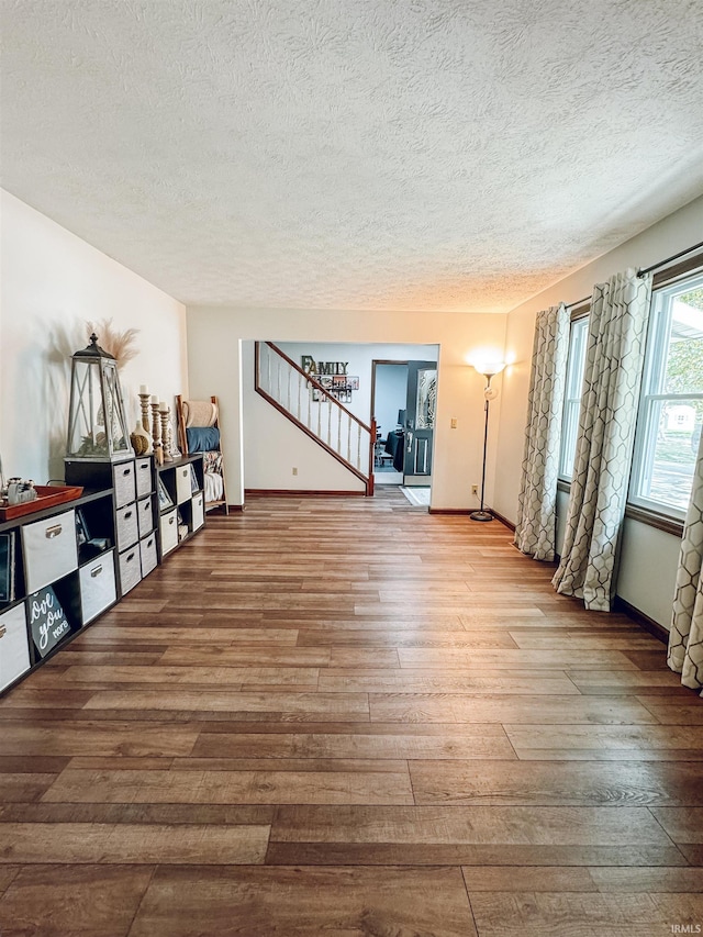 interior space with hardwood / wood-style flooring and a textured ceiling