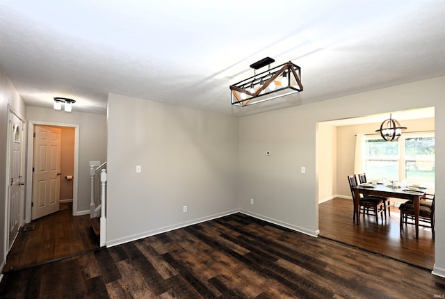 dining room with an inviting chandelier and dark hardwood / wood-style flooring