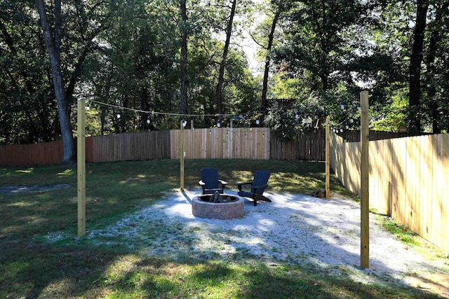 view of yard with a fire pit