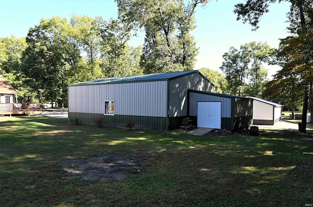 view of outbuilding featuring a yard