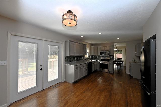 kitchen featuring french doors, appliances with stainless steel finishes, dark hardwood / wood-style flooring, and tasteful backsplash