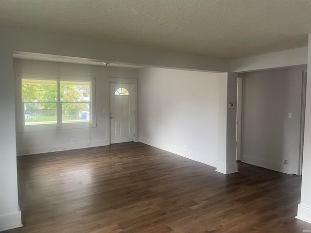 interior space featuring dark hardwood / wood-style floors and a textured ceiling