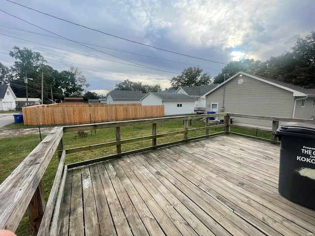 wooden terrace featuring a yard