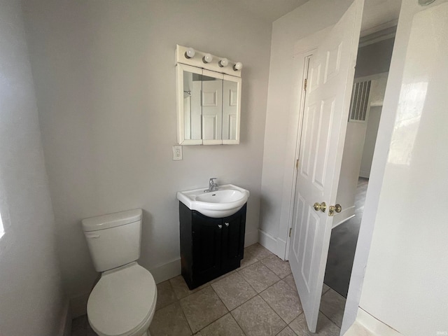 bathroom featuring tile patterned flooring, vanity, and toilet